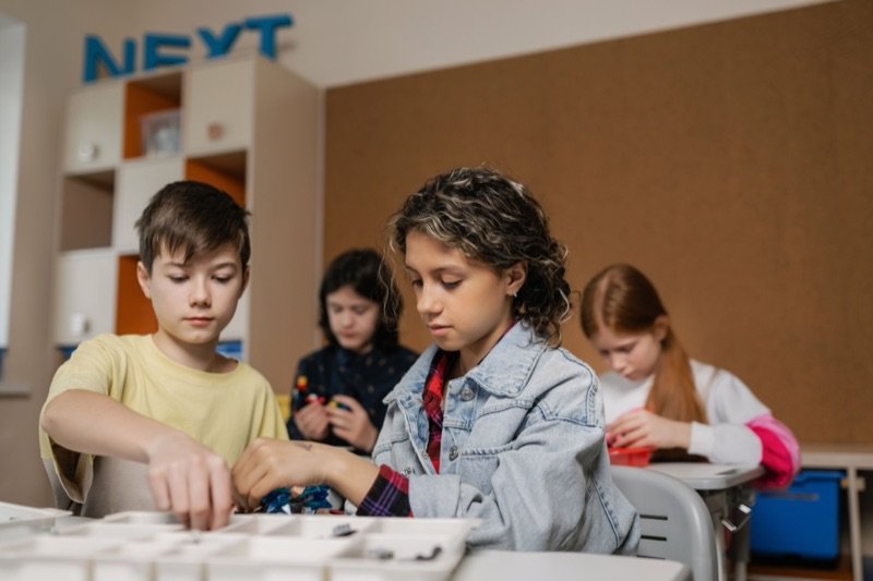 Elementary students building a robotics project